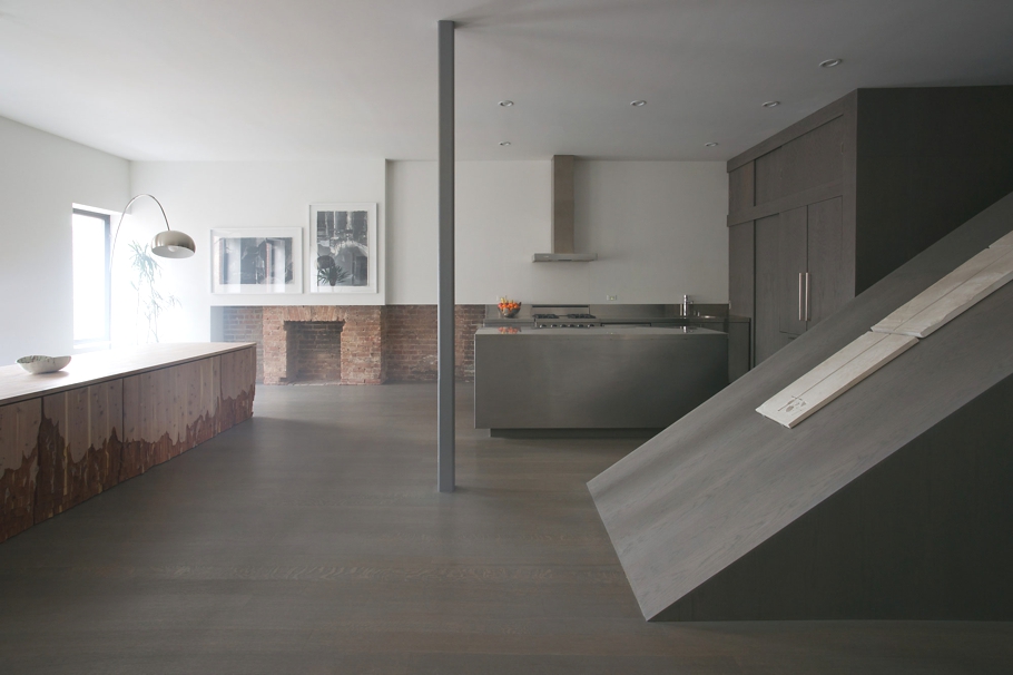 Минималистический интерьер стальной кухни в двухуровневой квартире в Бруклине